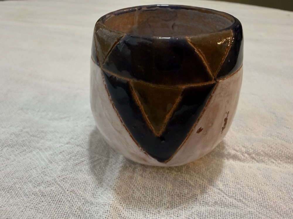 Handmade clay pottery with a distinct glazed finish.