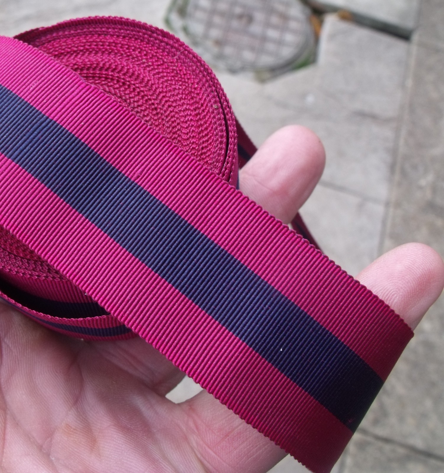 A 40 INCH LENGTH OF UNUSED OLD STOCK SILK DCM MEDAL RIBBON.