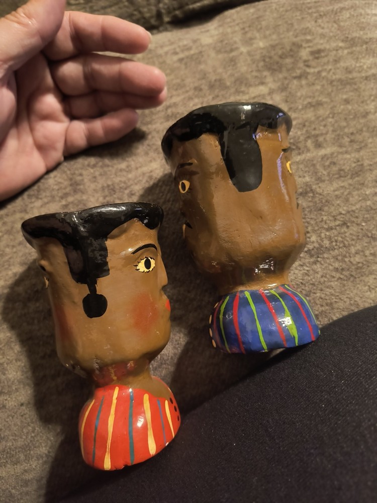 These items are handcrafted ceramic face vases or pots