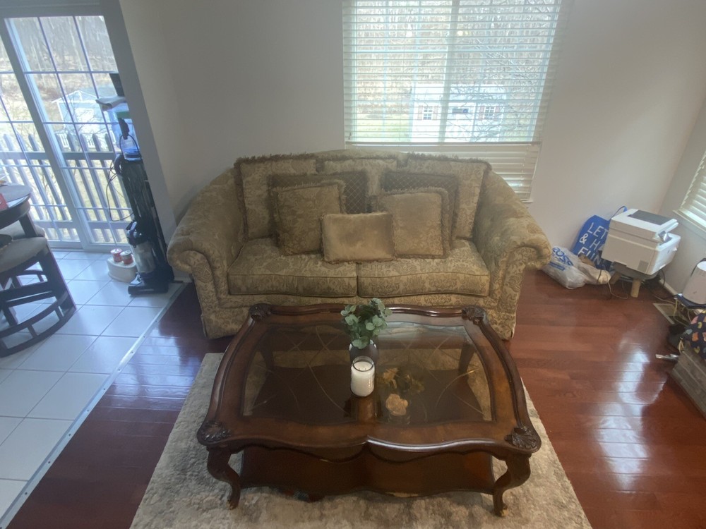 A Set Of Beige Sofas And A Coffee Table