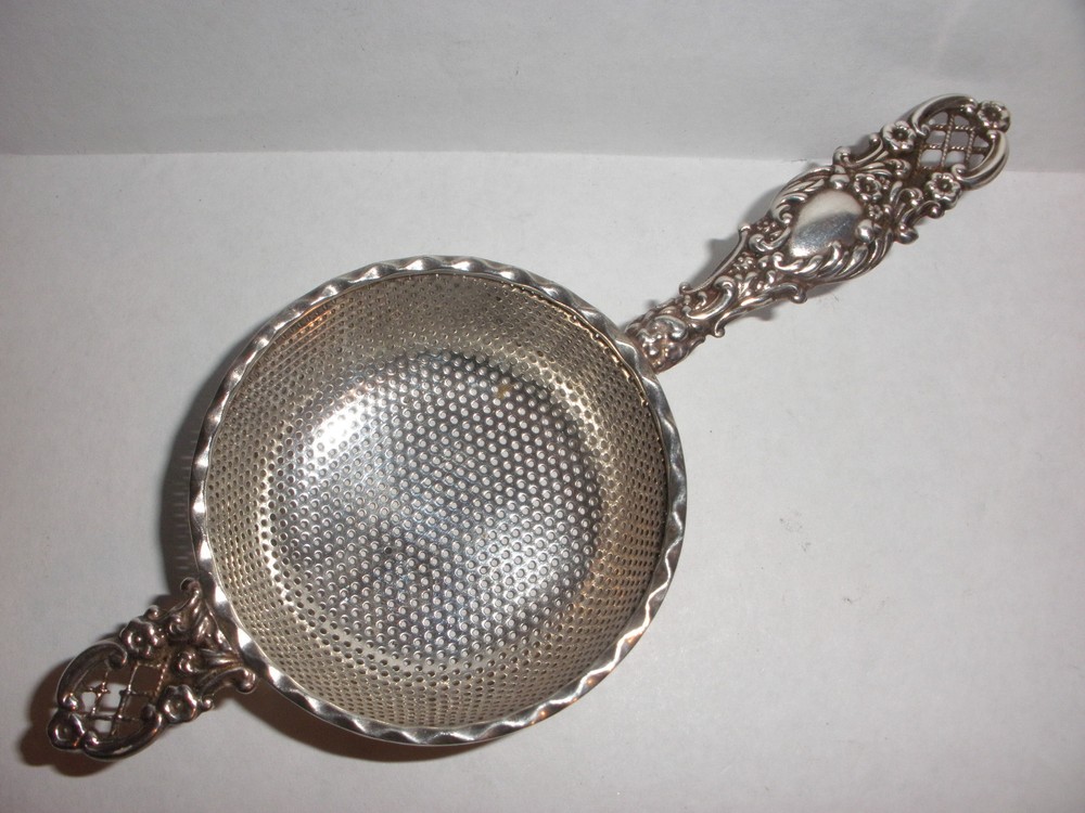 Nice Antique Continental  silver flowers repousse tea strainer