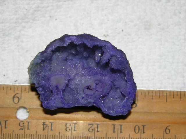 Geode cut & polished half with colored crystal center 2 inch E10