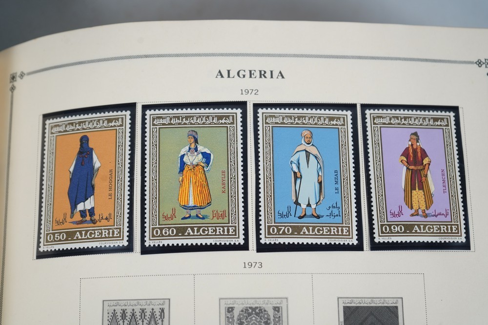 WORLDWIDE A-L 1970s COLLECTION OF 875+ STAMPS MINT & USED STORED IN SCOTT ALBUM