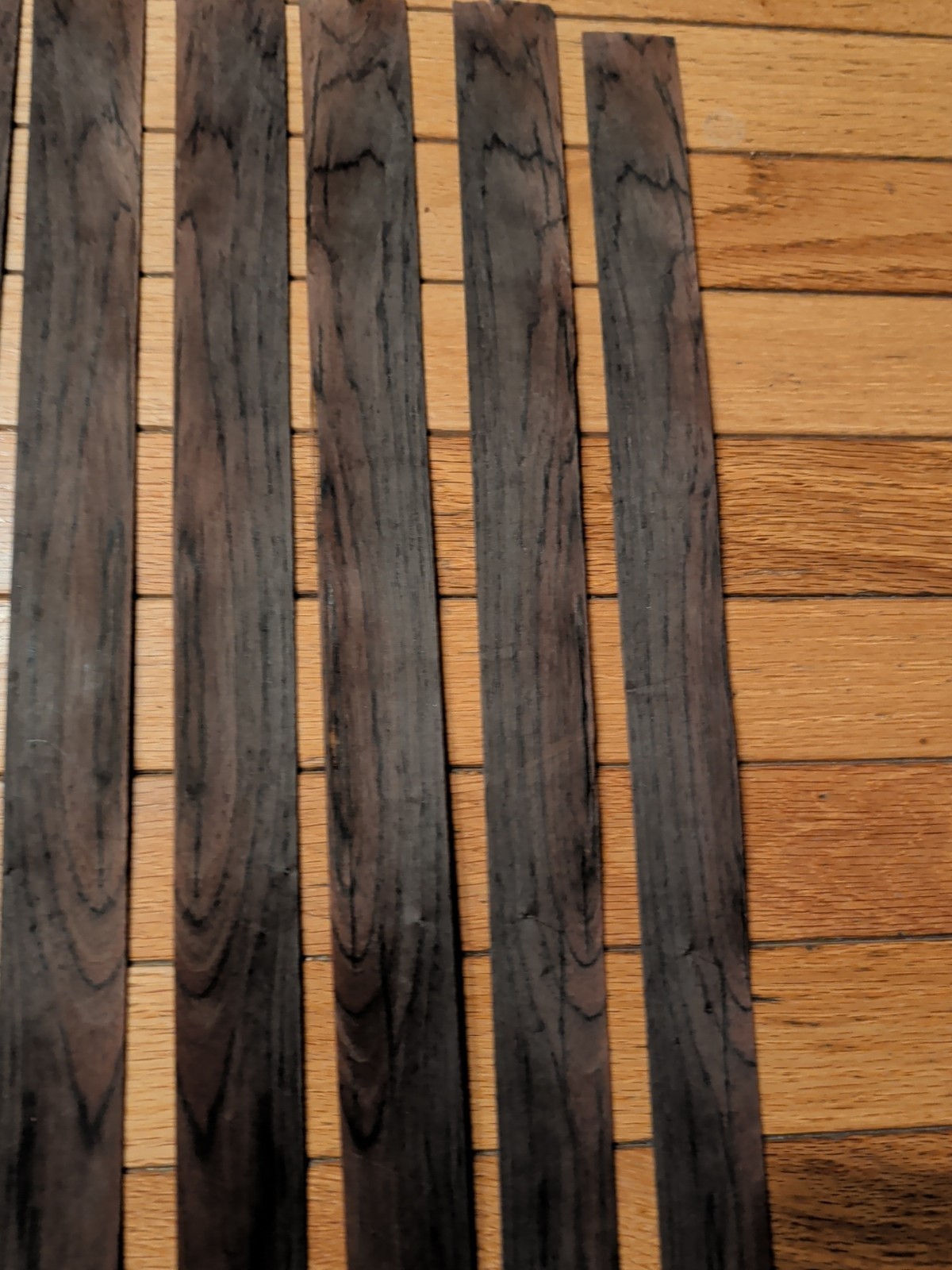 7 pieces of rosewood veneer 1 1/4" to 1 1/2" x 24 1/2" each raw 1/42"