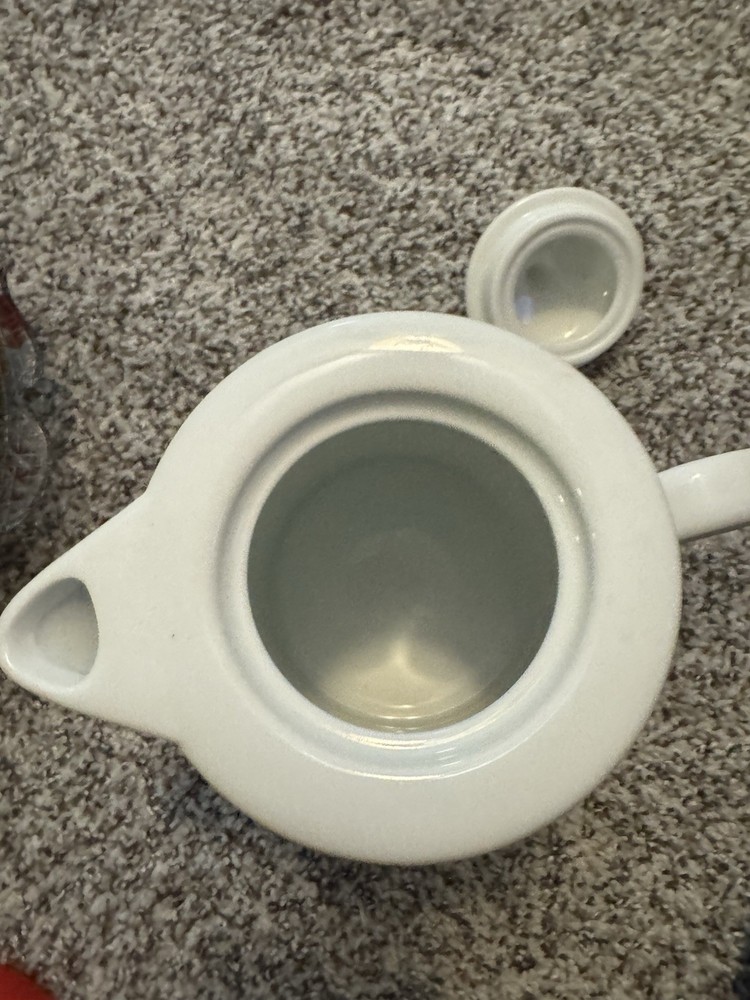 white ceramic teapot with a "Retired Pharmacist" design.