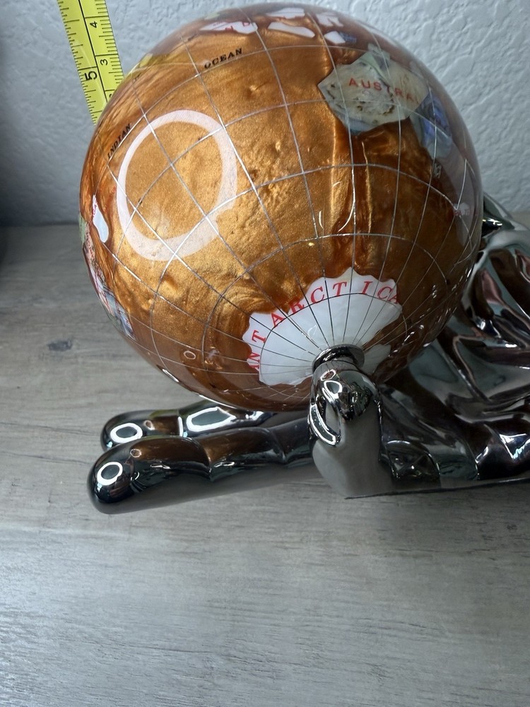 hand holding gemstone globe decor