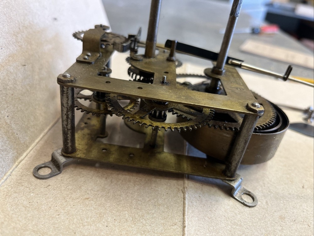 ANTIQUE E INGRAHAM CO CLOCK MOVEMENT AND PENDULUM BOB