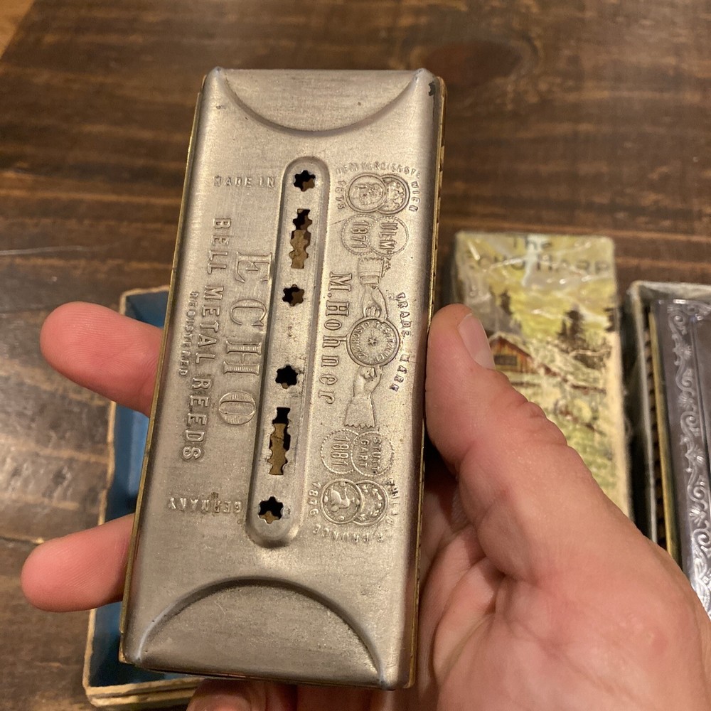 two M Hohner Echo harmonicas with rough boxes dofferent styles