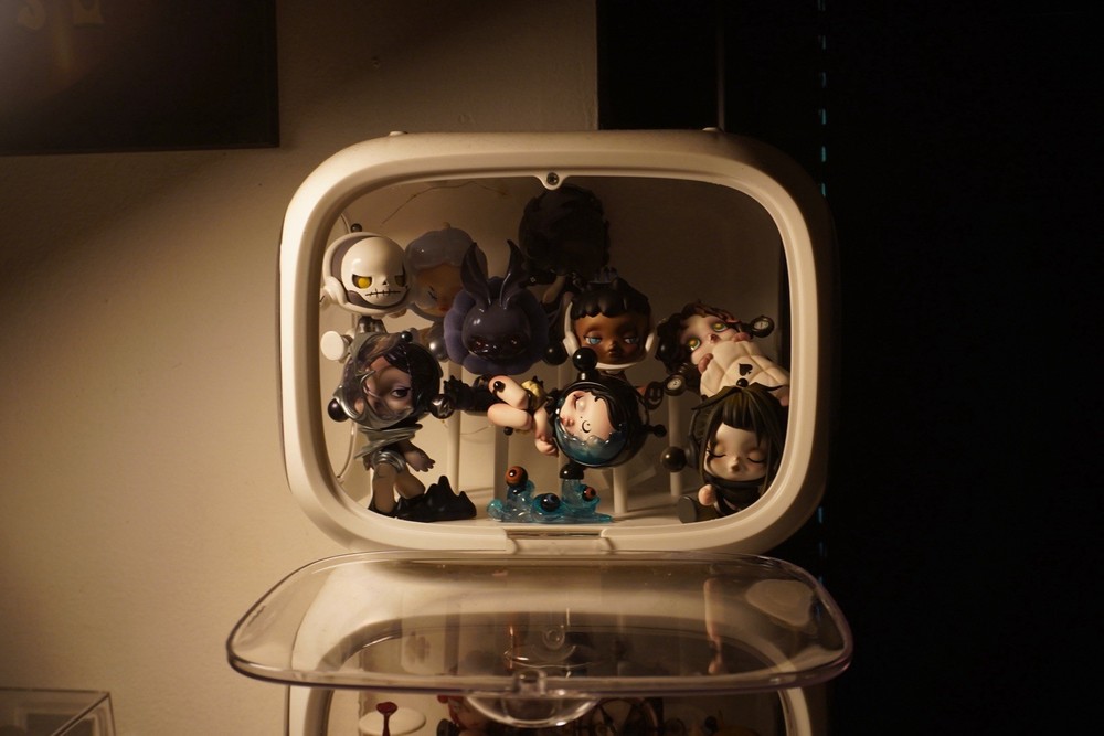 White display case with 17 Skillpanda figures.  both in excellent condition