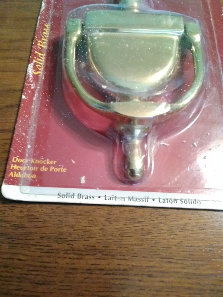 Brass Door Knocker. Unopened, but packaging rough. Solid.