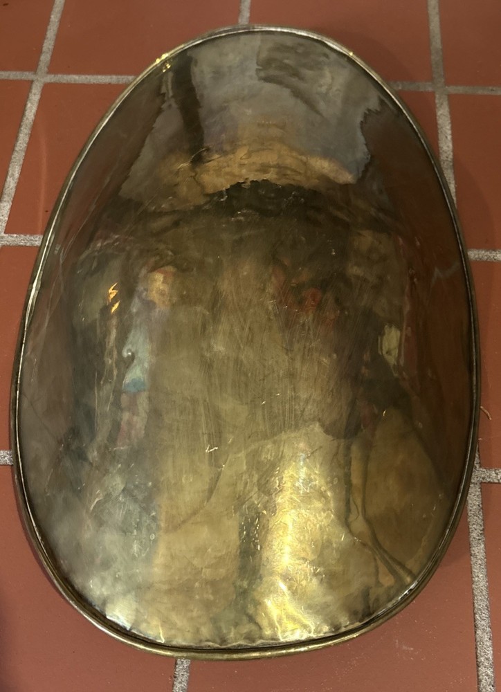 A large, antique solid brass mercantile scale pan.