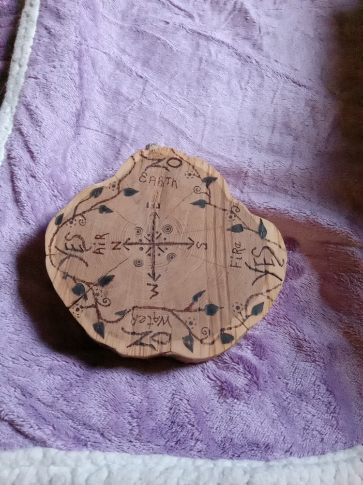 A handcrafted/carved/wooden pendulum board