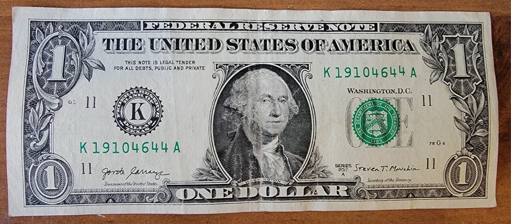 One dollar bill turn digit gas pump note