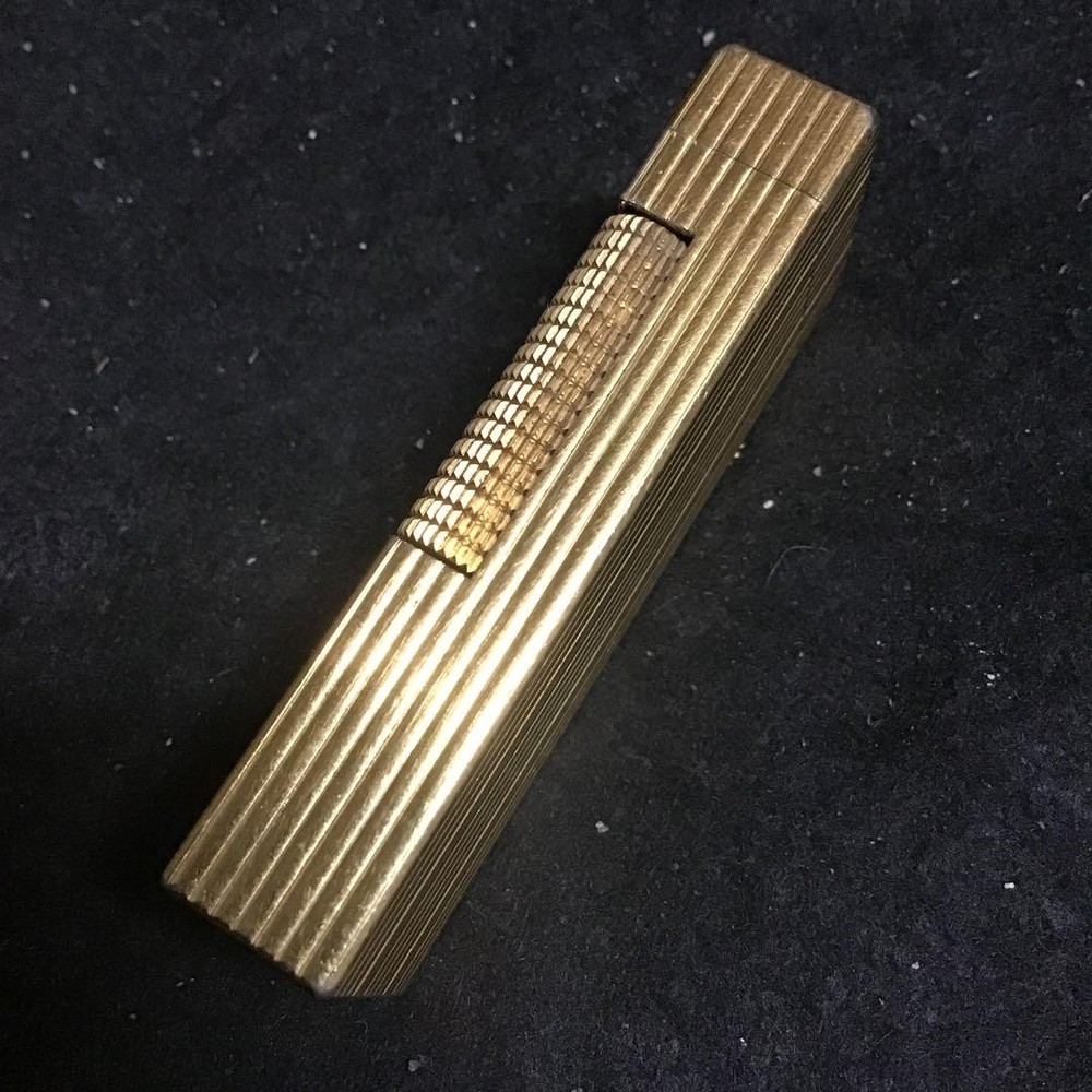 Overhauled gold dunhill lighter with striped pattern, ignition functioning well