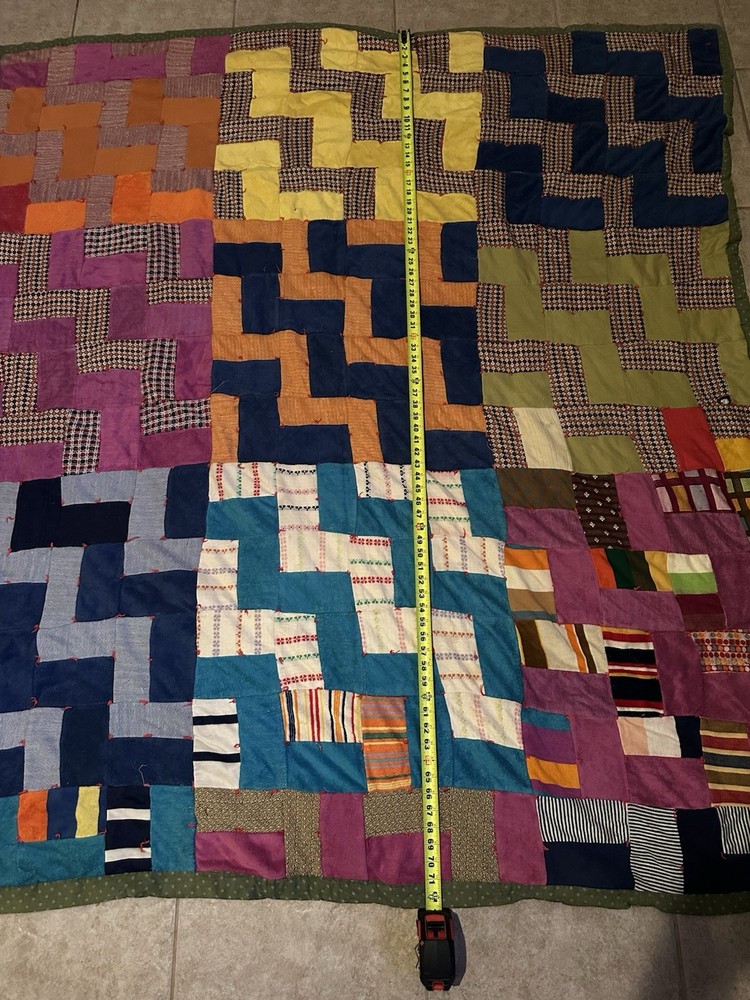 Handmade patchwork quilt with geometric 'L' block pattern.