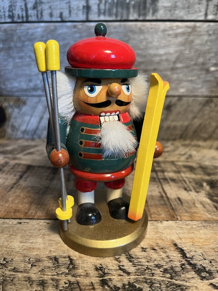 Vintage Christmas Nutcracker Holding Skies