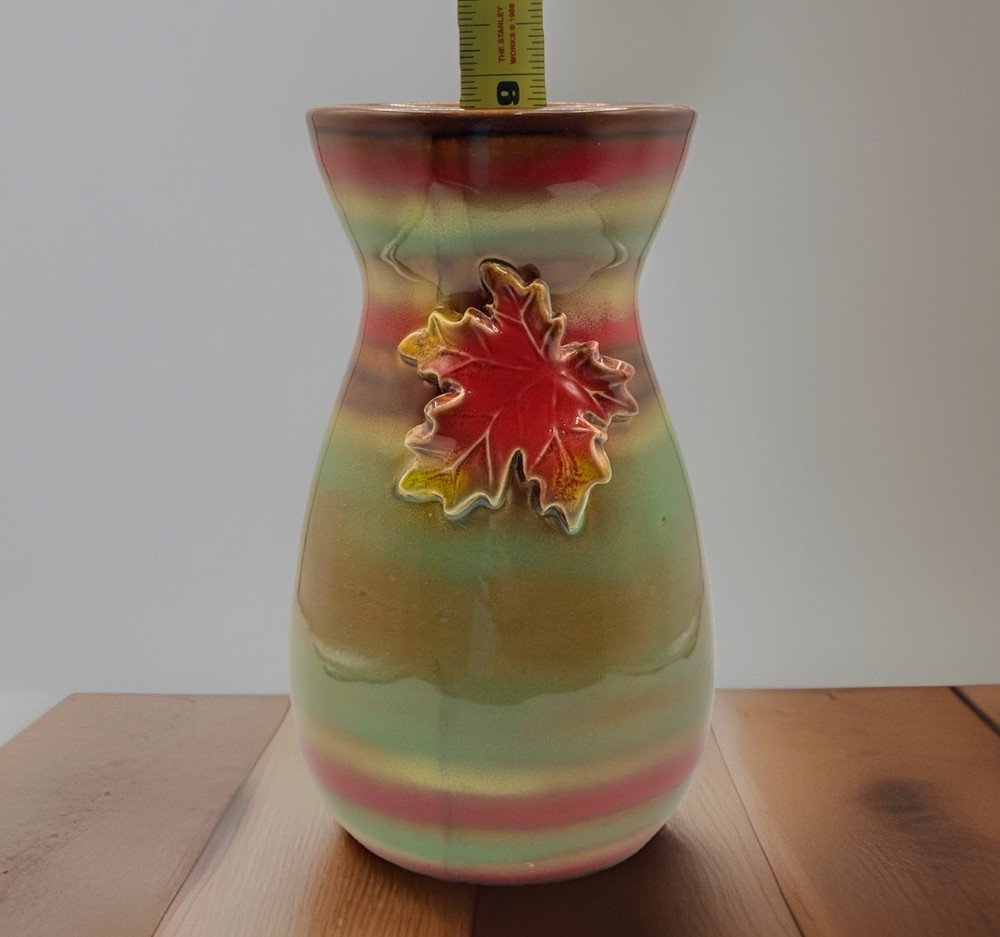 Stunning/9”/ceramic vase with a maple leaf design and a metallic glaze.