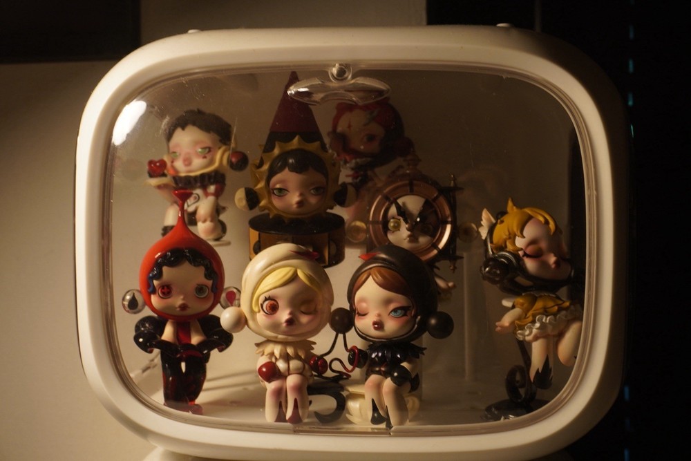 White display case with 17 Skillpanda figures. both in excellent condition