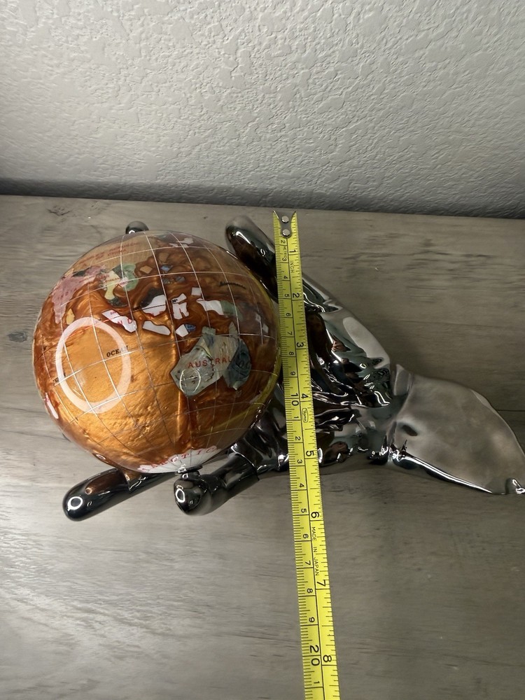 hand holding gemstone globe decor