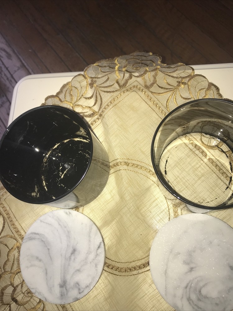 2 empty black candle jars with marble like lid