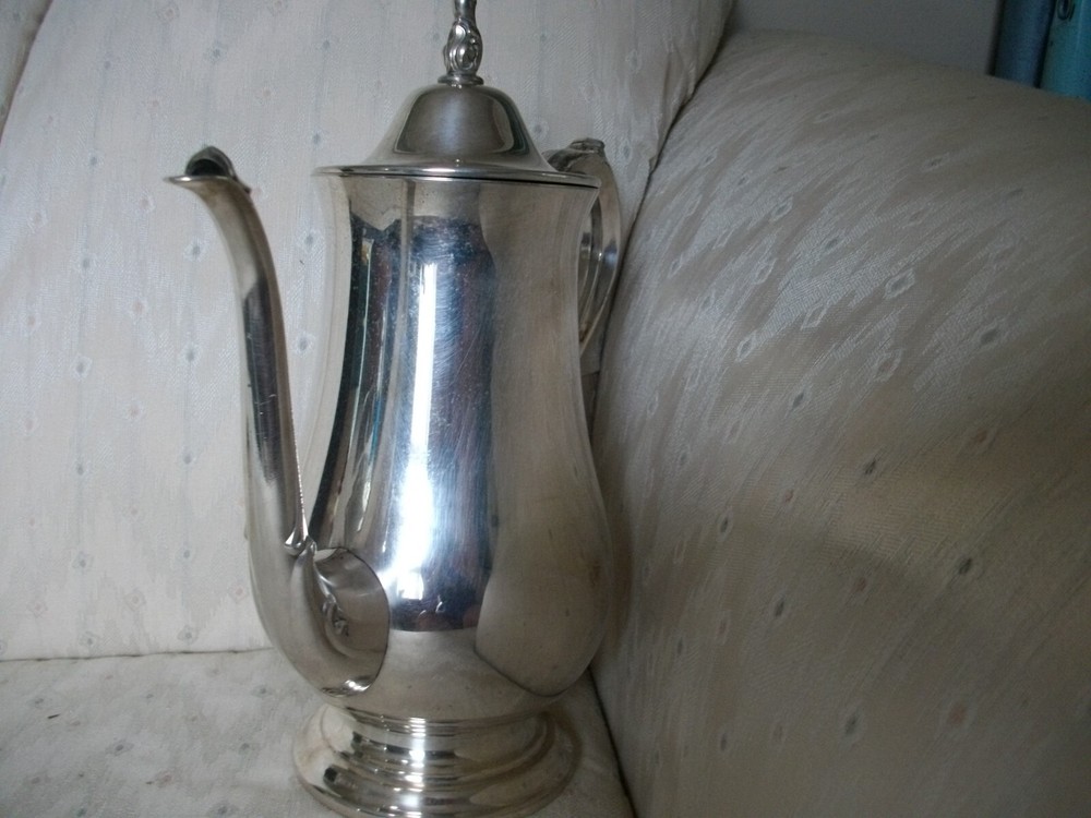 Silver coffee pot with insulated handle round bottom