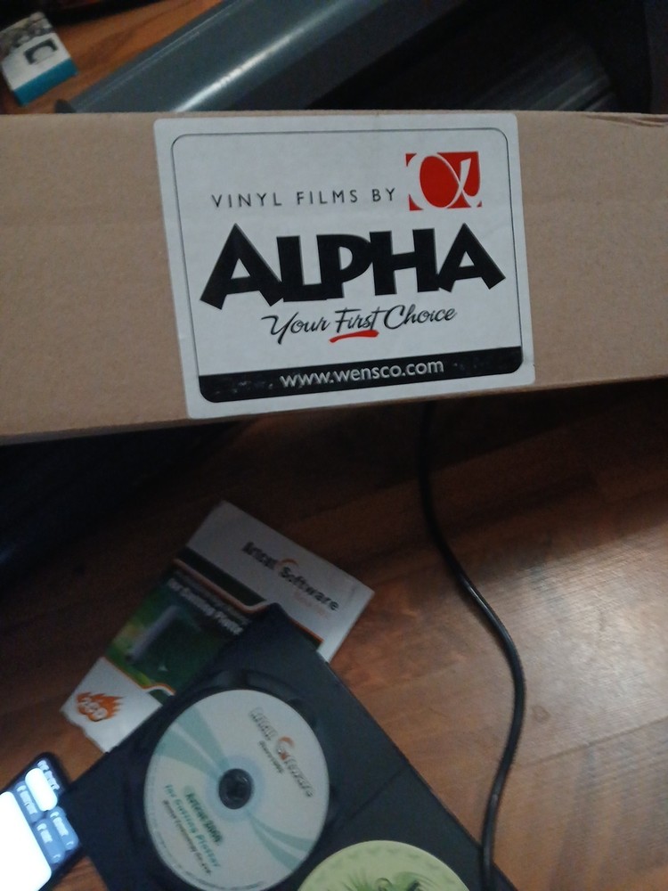 computer-controlled vinyl cutter machine Some Vinyl Material And Two Discs