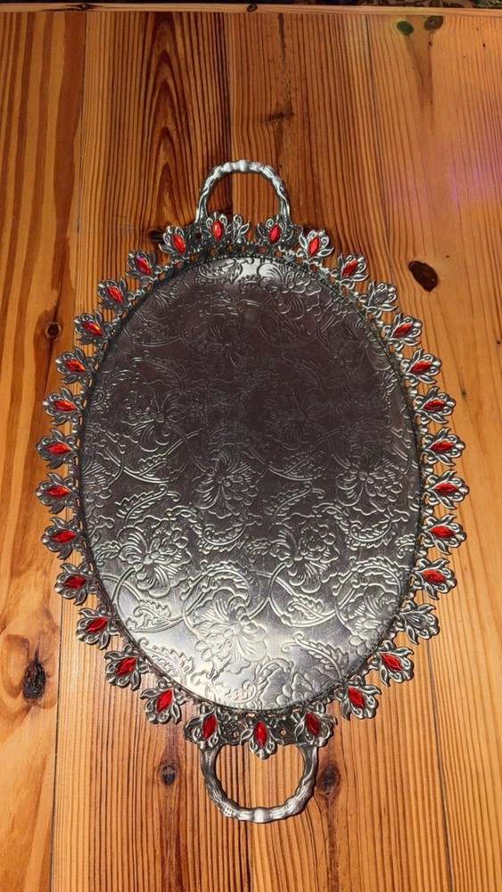 Thin silver tray with red jewels