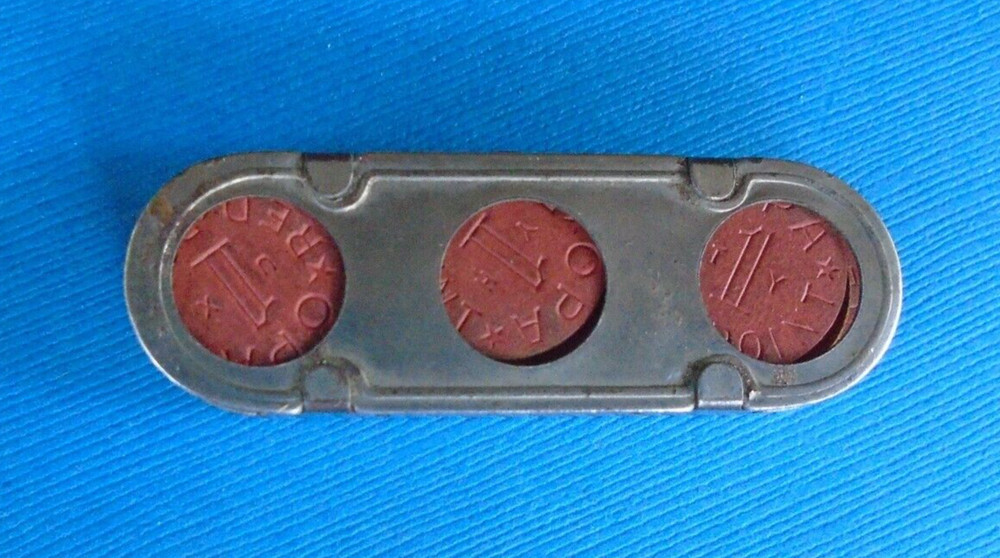 WWII home front ration token holder, made by Millgate, with some tokens