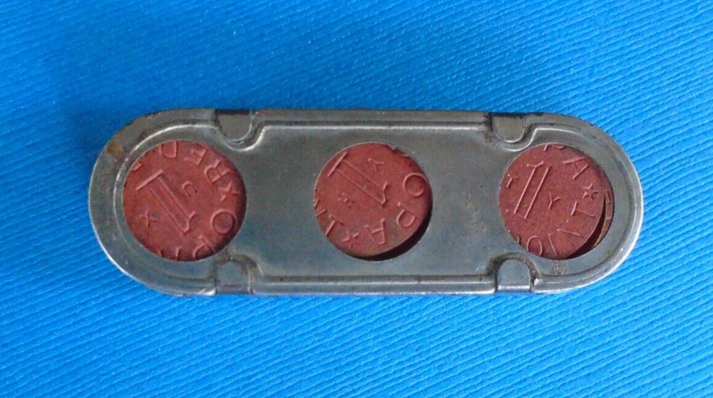 WWII home front ration token holder, made by Millgate, with some tokens