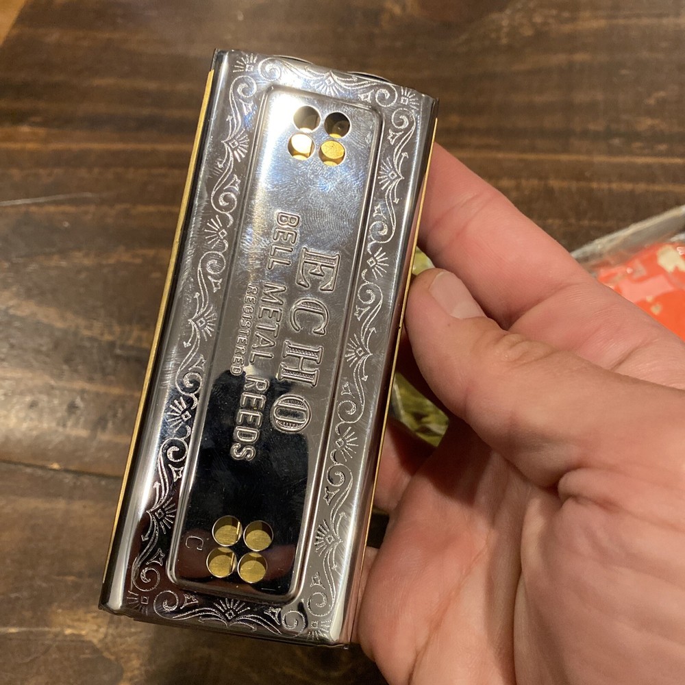 two M Hohner Echo harmonicas with rough boxes dofferent styles