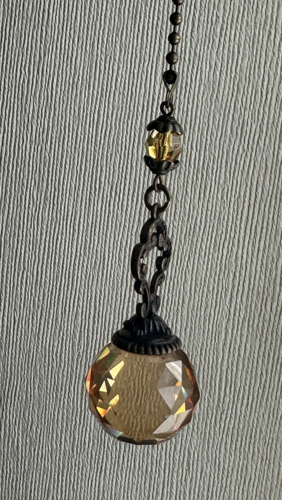 Decorative chain pull featuring amber crystals