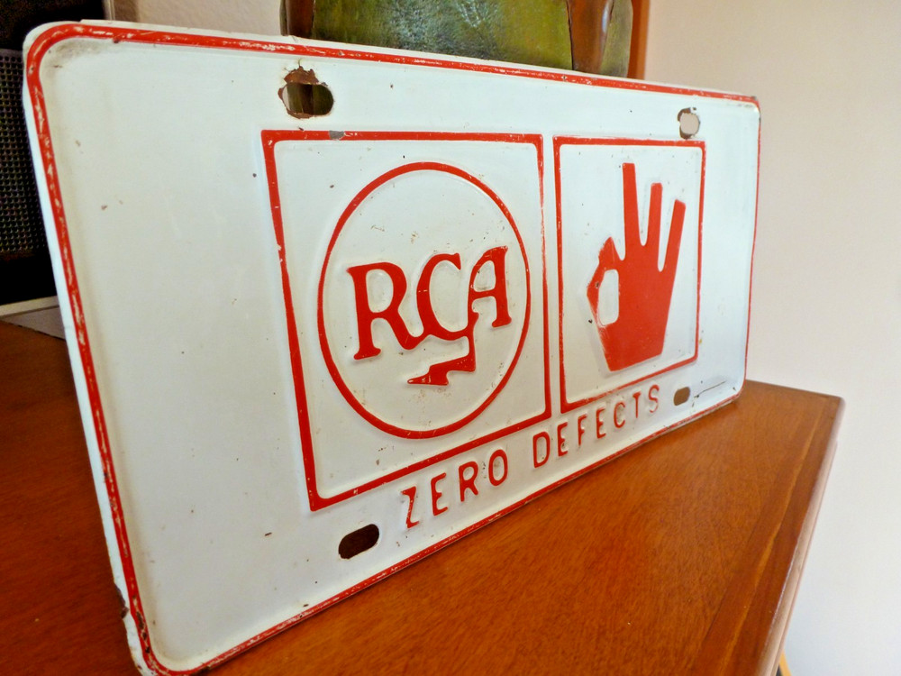 Embossed RCA Zero Defects License Plate from 1964
