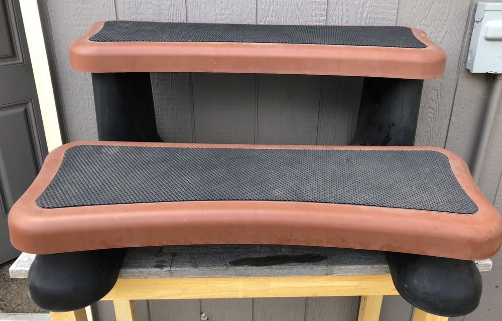 hot tub / spa steps in rust colored plastic..