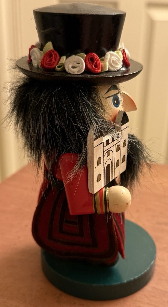 RED STUBBY MULTICOLOR WOODEN NUTCRACKER W/FLOWERED HAT - ENGLISH