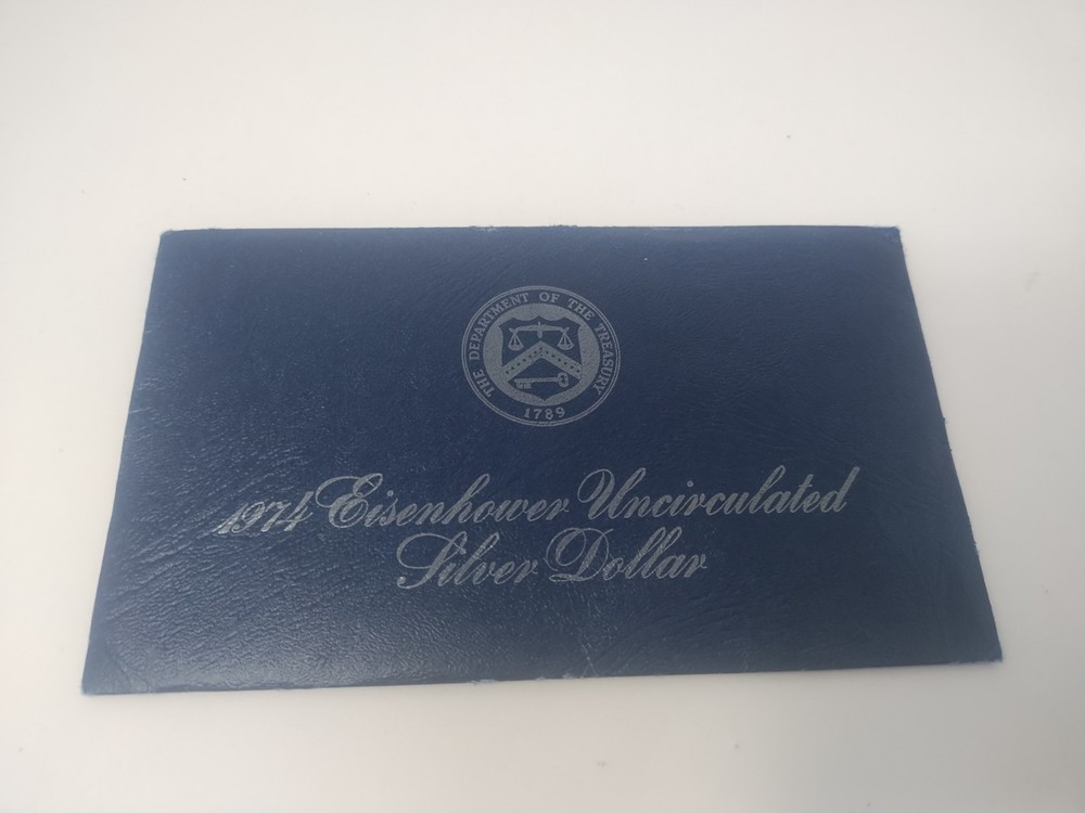 1974 Eisenhower 40% Silver Dollar. Blue Ike envelope with COA and Token US Mint