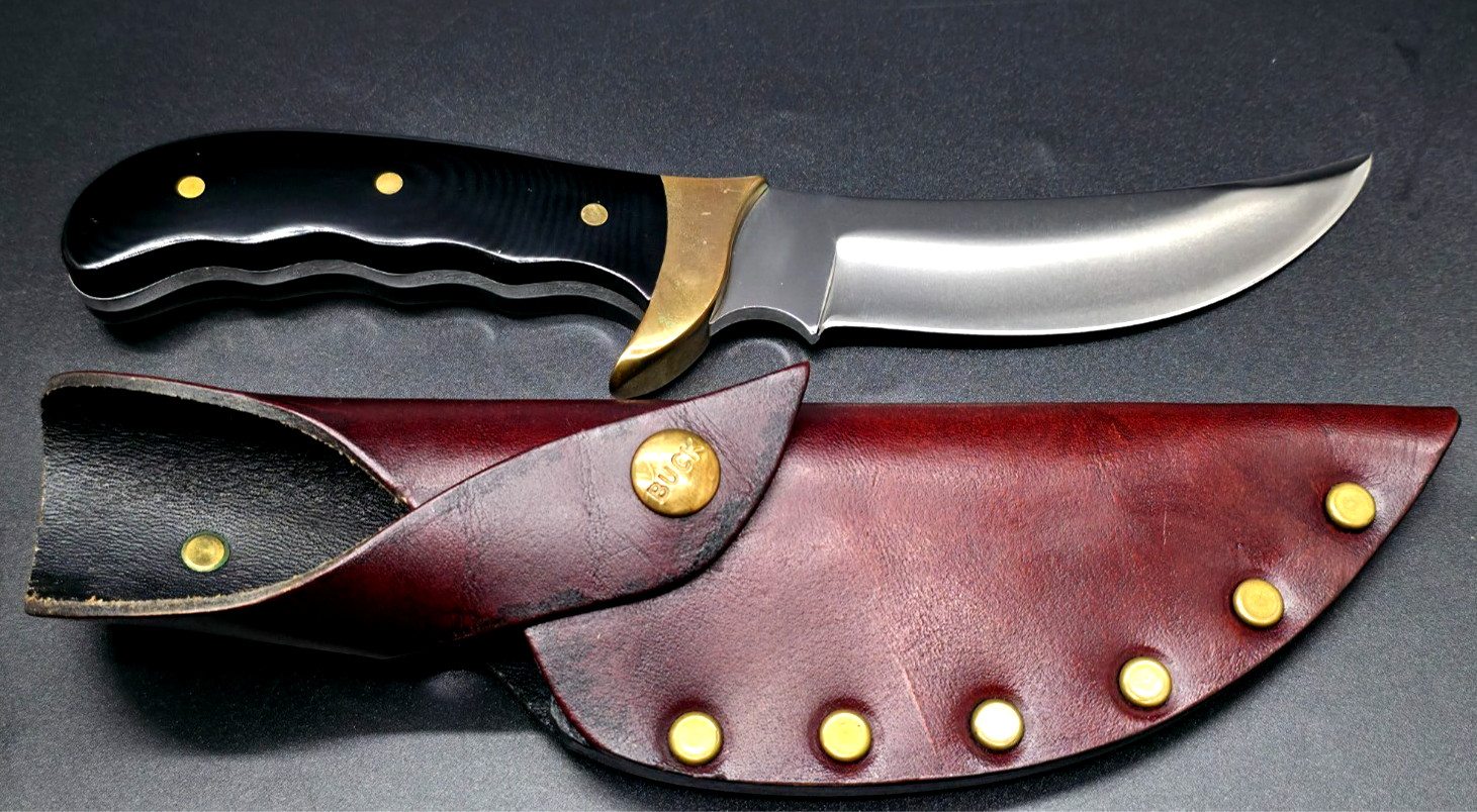 Buck Kalinga knife with black handle and brown leather sheath