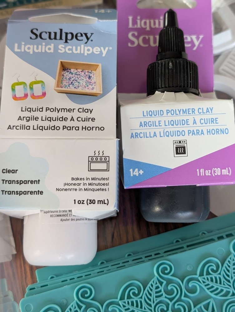 CLAY CUTTERS AND sculpey liquid clay and texture sheets.