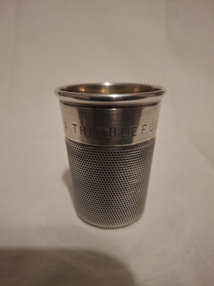 Sterling silver, shot jigger shape like oversized thimble.