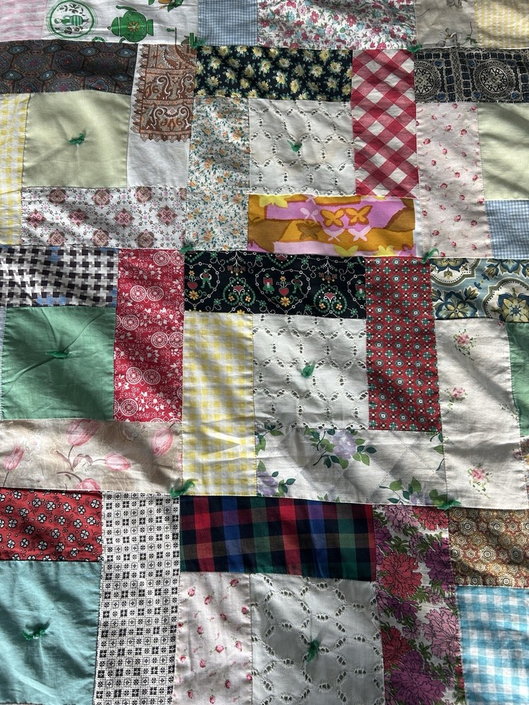 Handmade patchwork quilt with mixed fabric patterns
