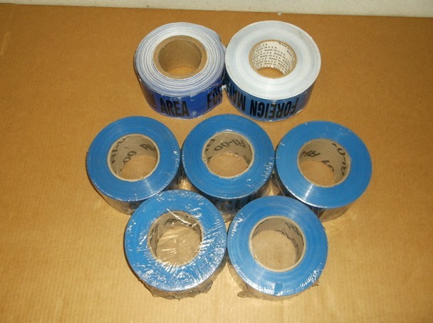 7 Blue Caution Tape Rolls That Read "Foreign Material Exclusion Area"