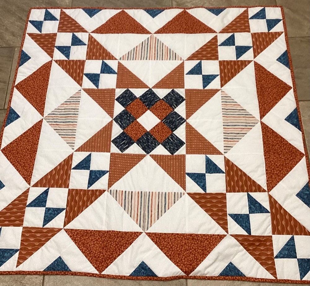 Handmade rust and blue lap quilt