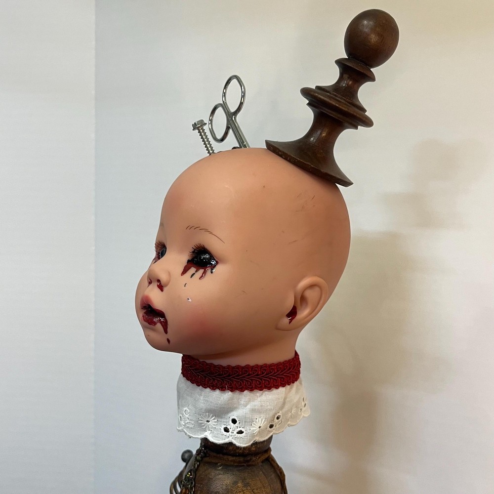 Creepy doll with scissors and key