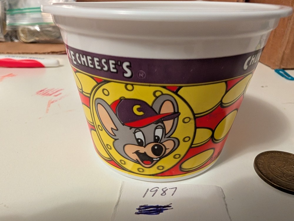 8. Old Chuck-E-Cheese Tokens And A Token Cup