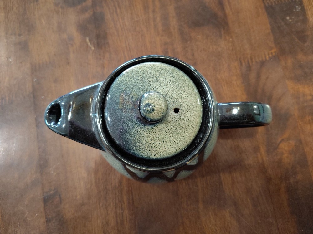black with green ceramic teapot