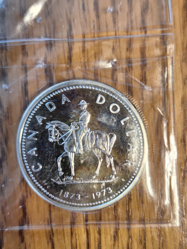 Rainbow Toned 1973 Canada RCMP Uncirculated Silver Dollar