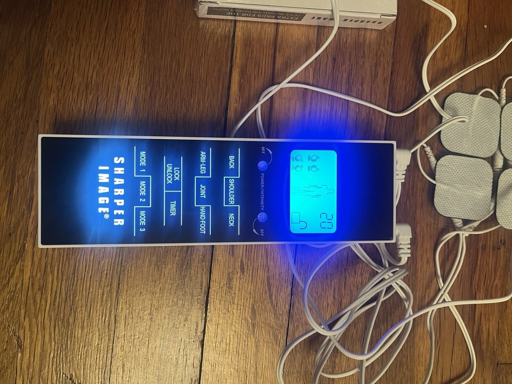 Sharper image tens massager with handheld control plus extra pads