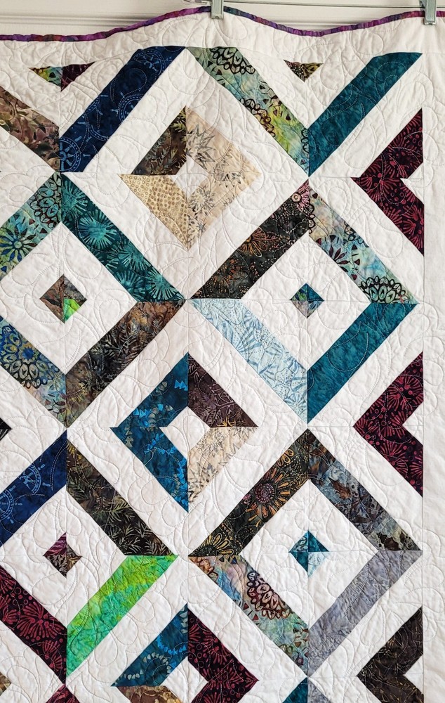 Hand made 55" X 62" Quilt In multiple batiks, purple batik back. Patchwork