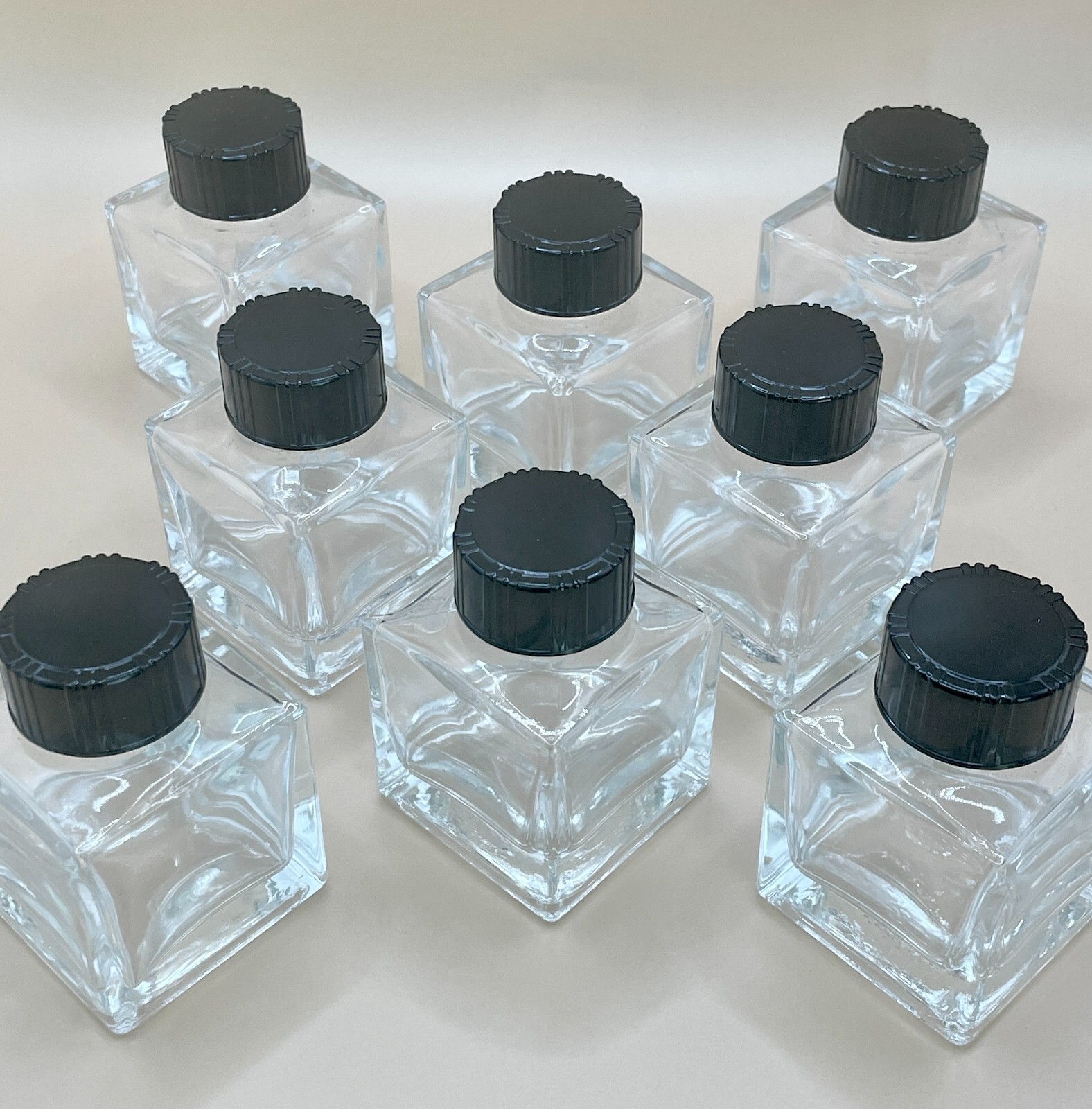 New, empty 50 ml glass square jars with lids,. Any quantity available