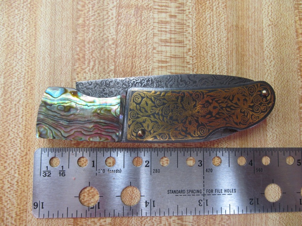 Custom Damascus folding knife. Abalone and gold leaf handles