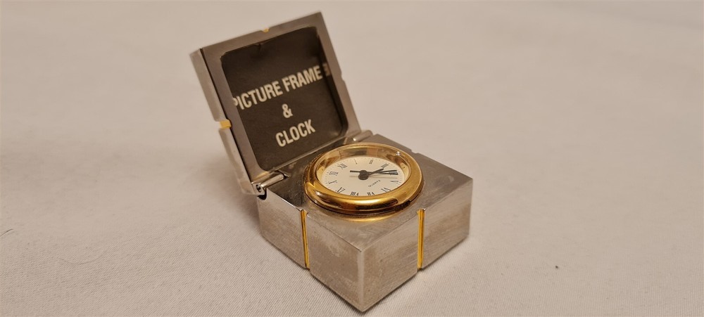 Gift mini clock with silver picture frame hidden inside gold trim